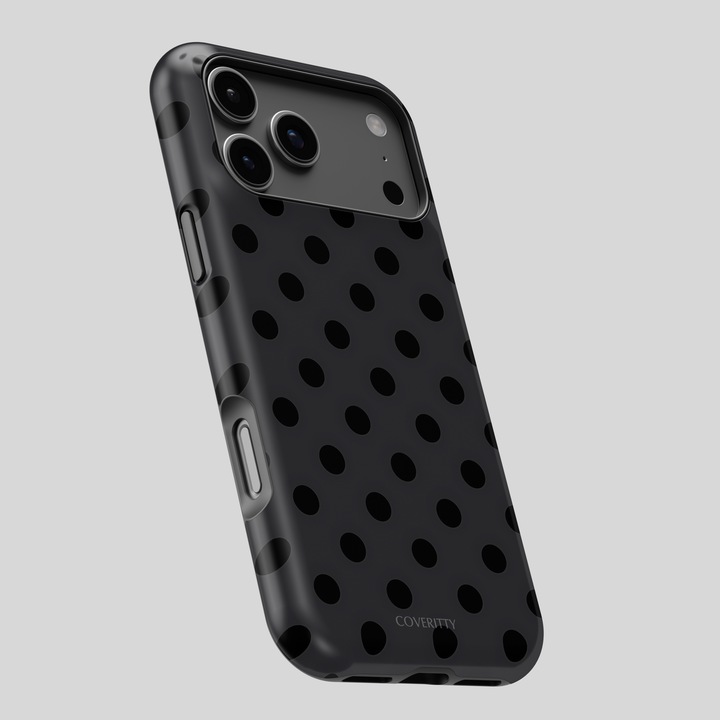 Black polka dot phone case on a gray background