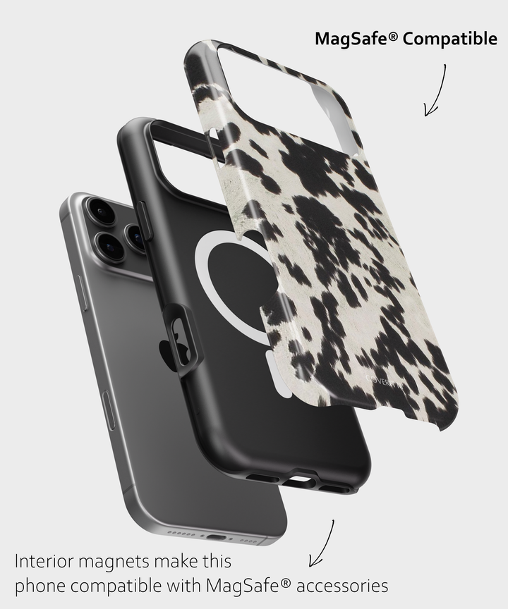 Phone case with cow print design and text indicating MagSafe compatibility on a light gray background