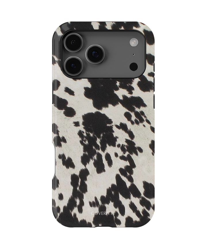 Phone case with black and white cow print pattern on a white background